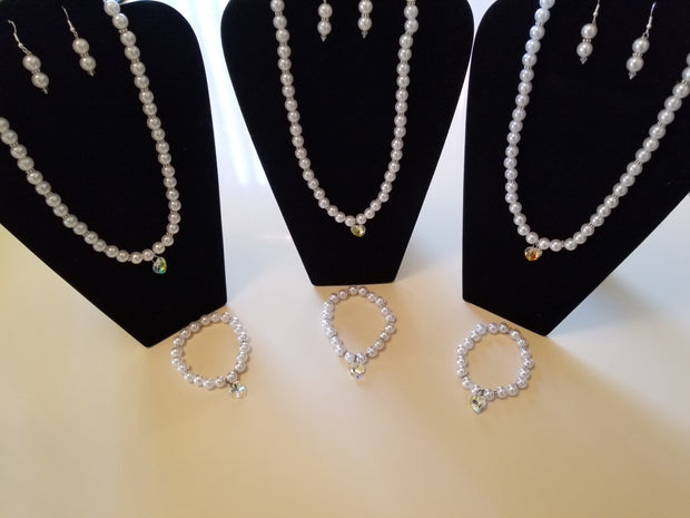 White plastic pearls with silver pieces and glass crystal pendant and bracelet with charm set
