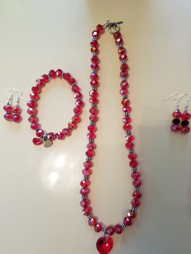 Red facet beads necklace with Swarovski pendant and18 inches and the bracelet stretch and matching earrings