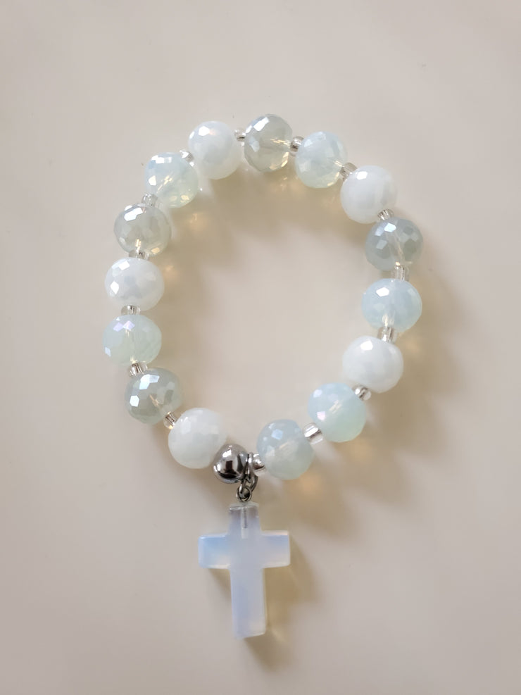 White like glass beads with a little different color and slightly bling and semi precious charms and the bracelets stretch