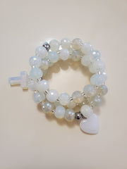 White like glass beads with a little different color and slightly bling and semi precious charms and the bracelets stretch